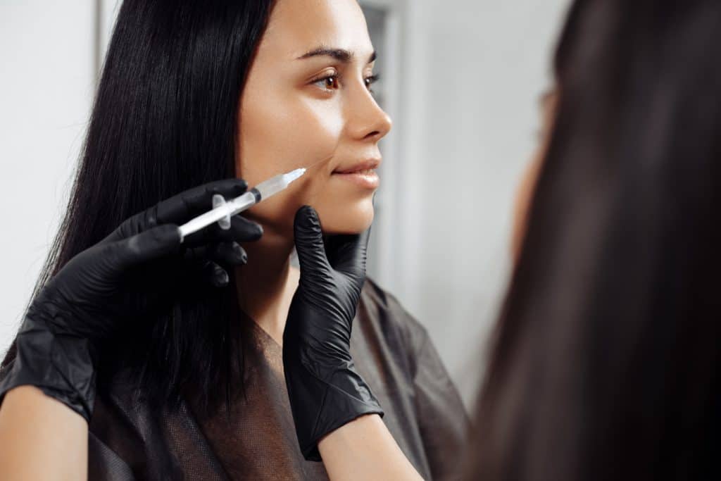 Caucasian women undergoing beauty spa botulinum neurotoxin Botox treatment for anti-aging, to smooth wrinkles as a cometic solution. Injecting face to relax muscles with a non-invasive procedure | Instinct Holistic Medical Spa IN Bozeman, MT